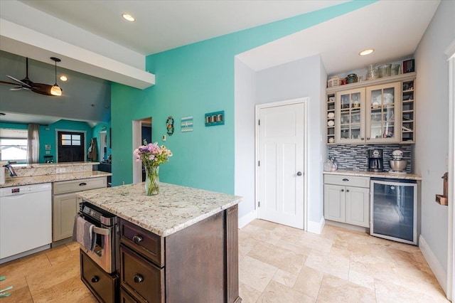 100 California St, Long Beach, NY 11561 - kitchen featuring wine cooler, white dishwasher, a ceiling fan, glass insert cabinets, and backsplash