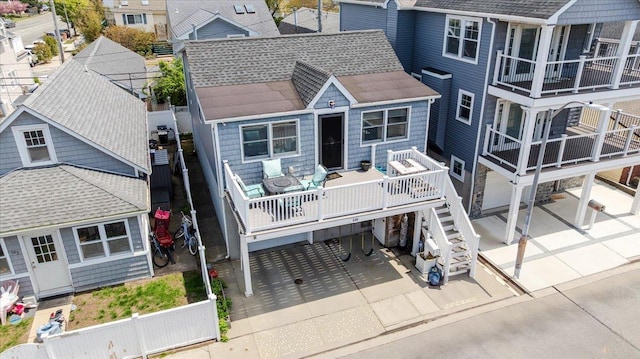 100 California St, Long Beach, NY 11561 - back of house featuring fence private yard, a wooden deck, a shingled roof, and a patio area