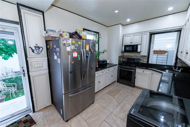 8521 80th St, Woodhaven, NY 11421 - kitchen featuring appliances with stainless steel finishes, dark countertops, a sink, and recessed lighting