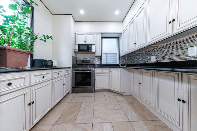 8521 80th St, Woodhaven, NY 11421 - kitchen featuring stainless steel gas range, black microwave, tasteful backsplash, and dark countertops