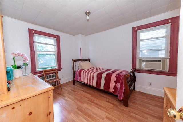 8521 80th St, Woodhaven, NY 11421 - bedroom with light wood-style flooring, cooling unit, and baseboards