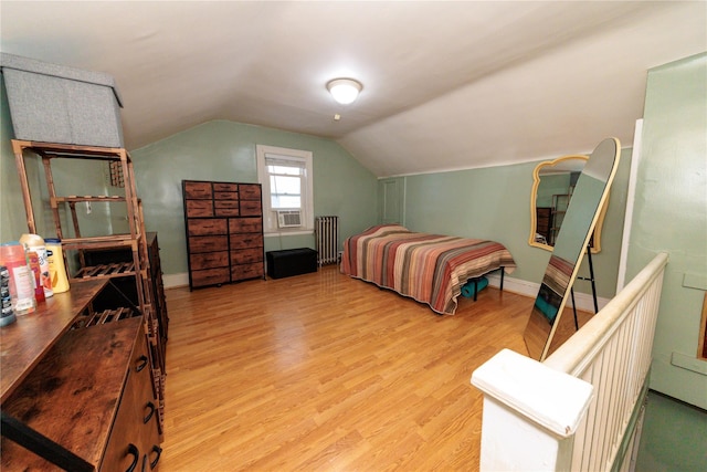 8521 80th St, Woodhaven, NY 11421 - bedroom featuring radiator, light wood-style flooring, vaulted ceiling, and baseboards