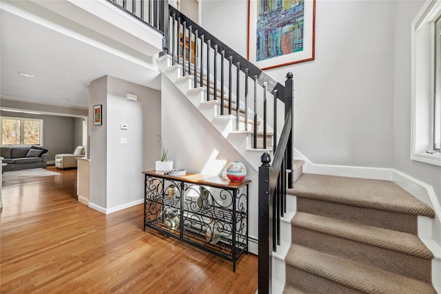stairway featuring baseboards and wood finished floors