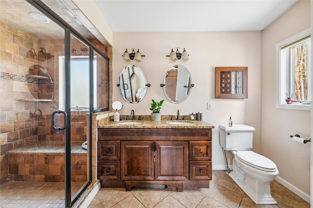 bathroom with a sink, a shower stall, and toilet