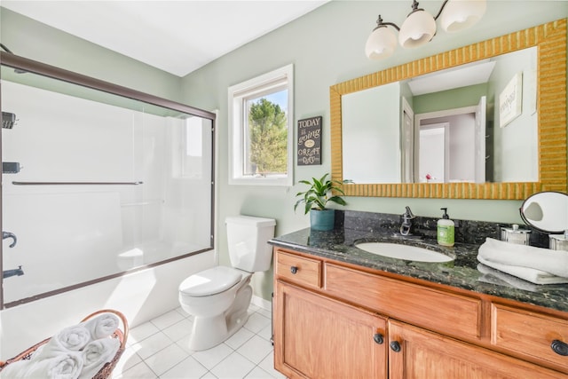 bathroom featuring tile patterned flooring, vanity, toilet, baseboards, and bath / shower combo with glass door