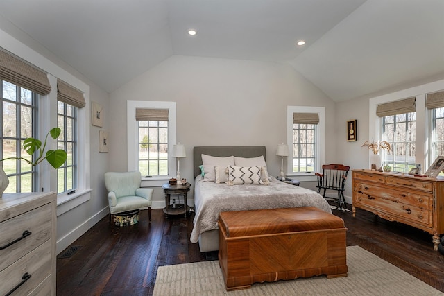 bedroom with vaulted ceiling, multiple windows, hardwood / wood-style flooring, and baseboards