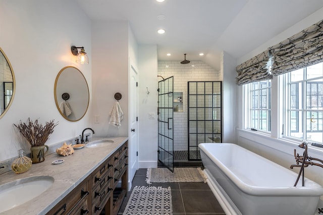 bathroom featuring plenty of natural light, a shower stall, a freestanding bath, recessed lighting, and tile patterned flooring