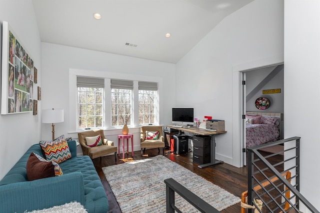 living area featuring dark wood finished floors, recessed lighting, and high vaulted ceiling