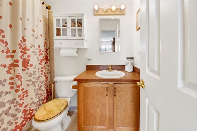full bath with a shower with curtain, tile patterned floors, vanity, and toilet