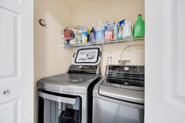 washroom featuring washing machine and dryer and laundry area