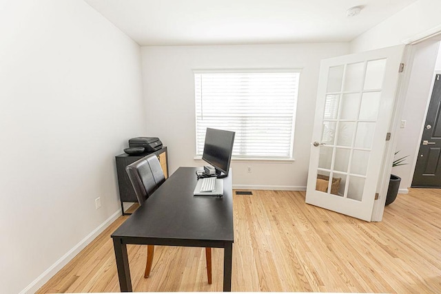 office area featuring baseboards and wood finished floors