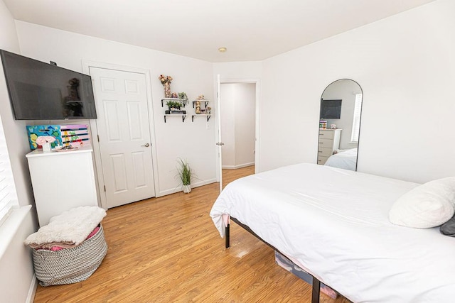 bedroom featuring baseboards and light wood-style flooring