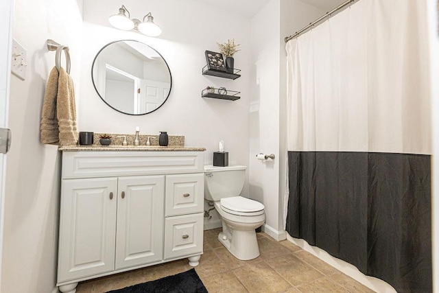 bathroom featuring toilet, tile patterned floors, vanity, and curtained shower