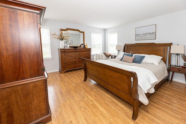 bedroom featuring light wood-style flooring and baseboards
