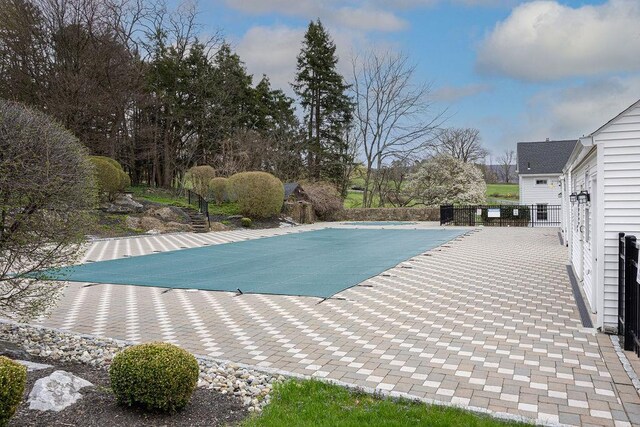 view of swimming pool featuring a fenced in pool and a patio
