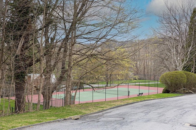 view of sport court featuring fence