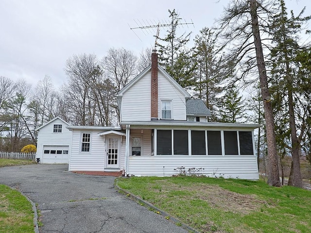 4073 Rte 9w, Saugerties, NY 12477 - view of front of house with driveway, a chimney, a detached garage, and a sunroom