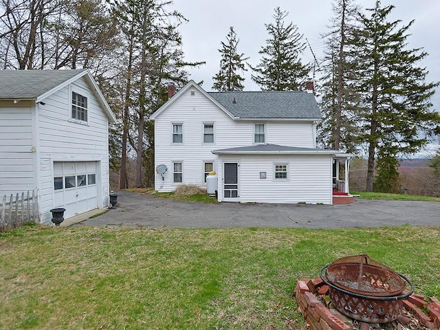 4073 Rte 9w, Saugerties, NY 12477 - rear view of property with a garage, a yard, a chimney, aphalt driveway, and a fire pit