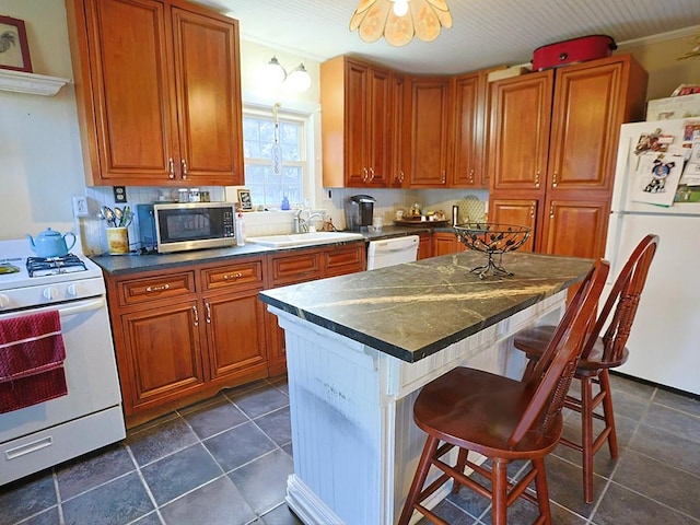 4073 Rte 9w, Saugerties, NY 12477 - kitchen with a sink, a kitchen breakfast bar, brown cabinetry, white appliances, and dark countertops