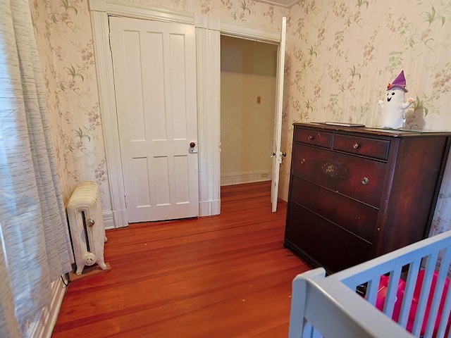 4073 Rte 9w, Saugerties, NY 12477 - bedroom with radiator, wallpapered walls, wood finished floors, and baseboards