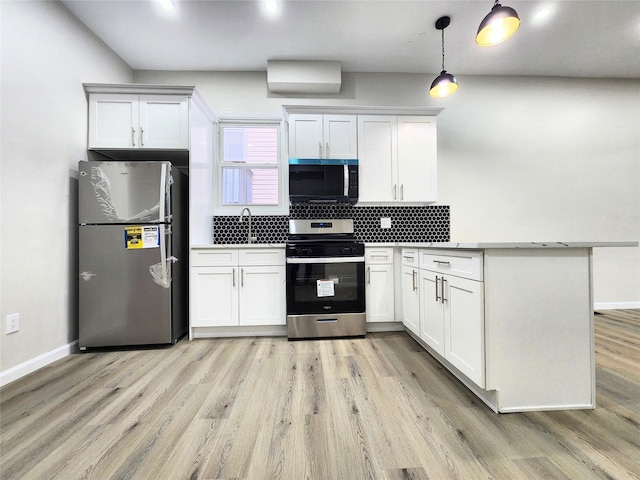 24 Wayne St, Staten Island, NY 10310 - kitchen with appliances with stainless steel finishes, a peninsula, a sink, backsplash, and baseboards