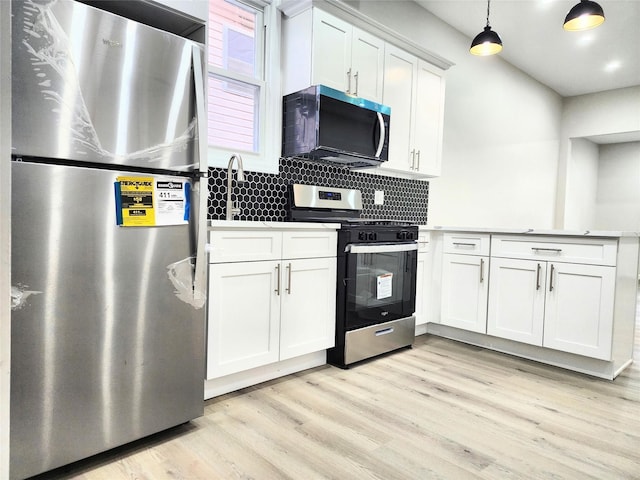 24 Wayne St, Staten Island, NY 10310 - kitchen featuring appliances with stainless steel finishes, light wood-type flooring, white cabinets, backsplash, and light countertops