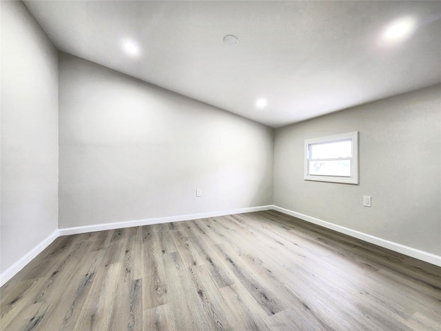 24 Wayne St, Staten Island, NY 10310 - unfurnished room with wood finished floors, baseboards, recessed lighting, and lofted ceiling
