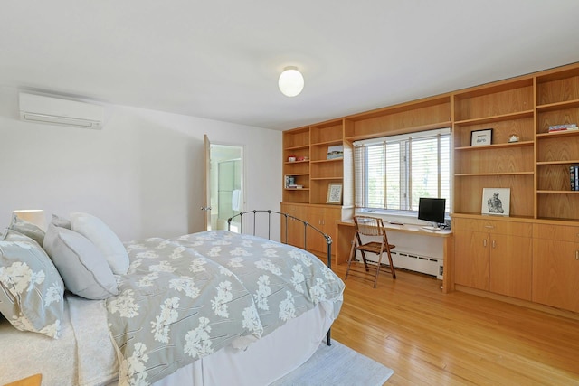 bedroom with light wood-style floors, a wall mounted AC, and baseboard heating