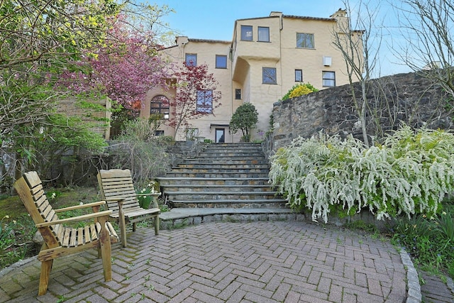 view of home's community featuring a patio area and stairway