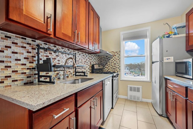 7510 Yellowstone Blvd Unit 6D, Rego Park, NY 11374 - kitchen with a sink, appliances with stainless steel finishes, light tile patterned floors, light stone countertops, and baseboards