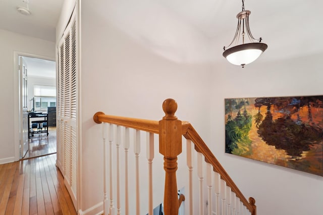 stairway featuring wood-type flooring and baseboards