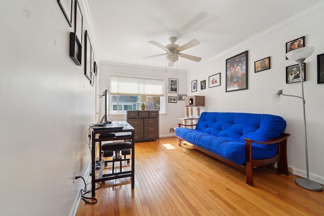 living area featuring a ceiling fan, baseboards, ornamental molding, and light wood finished floors