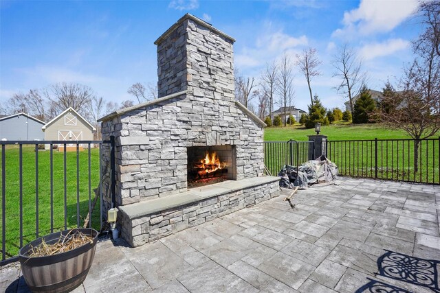 view of patio with fence and an outdoor stone fireplace
