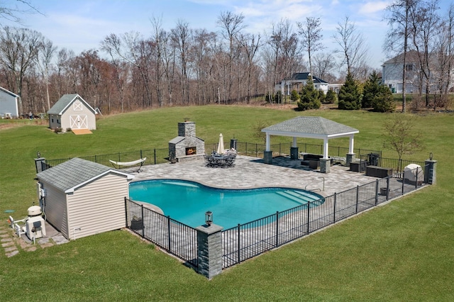 view of pool featuring a gazebo, a patio area, a lawn, fence, and an outbuilding