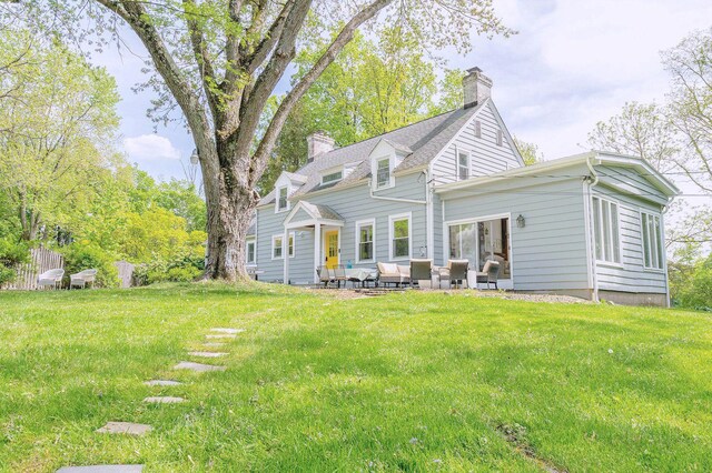 893 Laroe Rd, Monroe, NY 10950 - rear view of house with a chimney, outdoor lounge area, a lawn, and a patio area