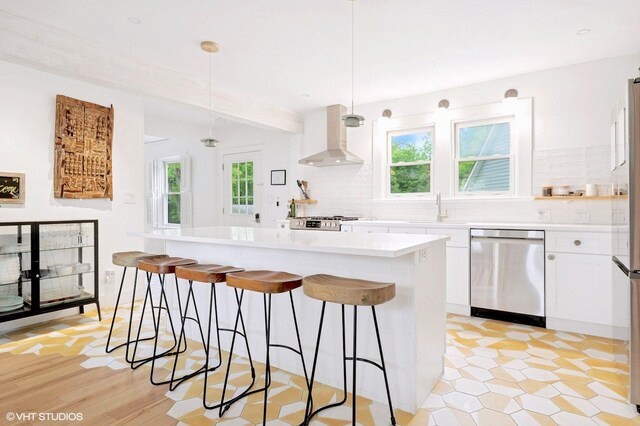 893 Laroe Rd, Monroe, NY 10950 - kitchen with dishwasher, wall chimney exhaust hood, healthy amount of natural light, and a center island