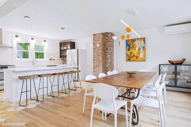 893 Laroe Rd, Monroe, NY 10950 - dining area with a wall mounted air conditioner and light wood-style flooring