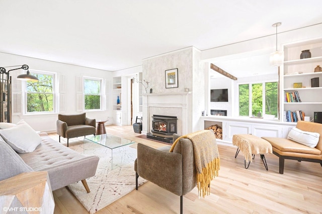 893 Laroe Rd, Monroe, NY 10950 - living room featuring wood finished floors, healthy amount of natural light, and a lit fireplace