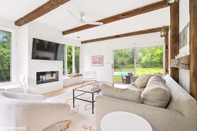 893 Laroe Rd, Monroe, NY 10950 - living room with wood finished floors, plenty of natural light, a ceiling fan, a brick fireplace, and beam ceiling
