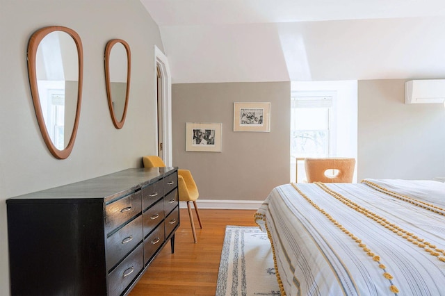 893 Laroe Rd, Monroe, NY 10950 - bedroom with an AC wall unit, light wood-style flooring, and baseboards