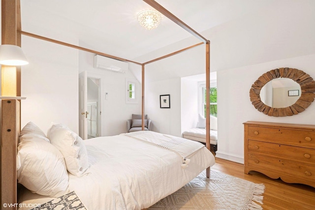 893 Laroe Rd, Monroe, NY 10950 - bedroom featuring wood finished floors, an AC wall unit, and lofted ceiling
