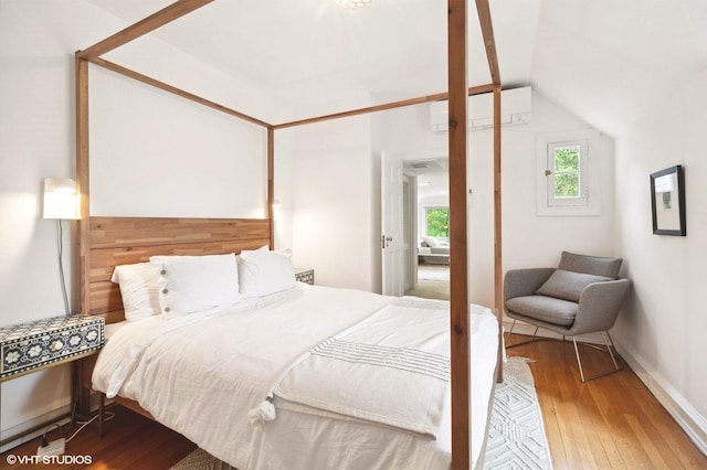 893 Laroe Rd, Monroe, NY 10950 - bedroom with a wall mounted air conditioner, wood-type flooring, and vaulted ceiling