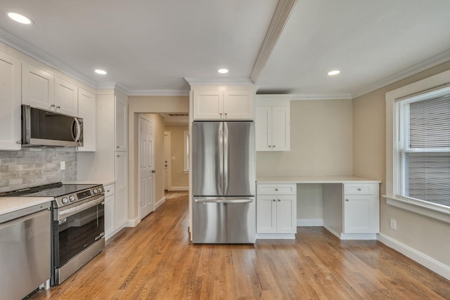 kitchen featuring tasteful backsplash, baseboards, white cabinetry, appliances with stainless steel finishes, and ornamental molding