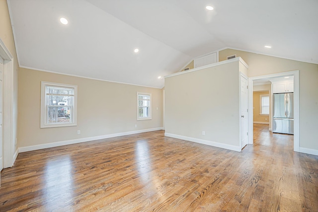 unfurnished living room featuring light wood finished floors, baseboards, lofted ceiling, visible vents, and recessed lighting