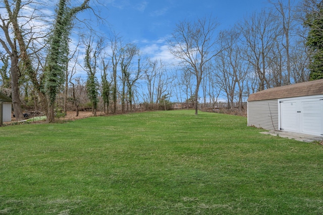 view of yard with an outbuilding and a shed