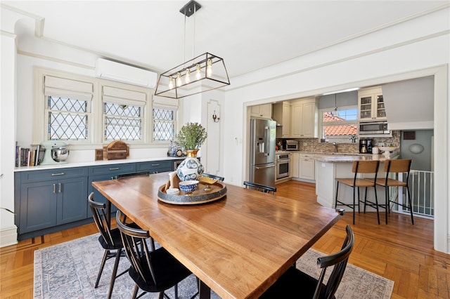 dining area featuring a wall mounted AC