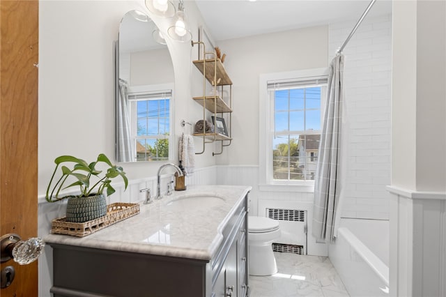 full bathroom featuring wainscoting, vanity, toilet, marble finish floor, and radiator