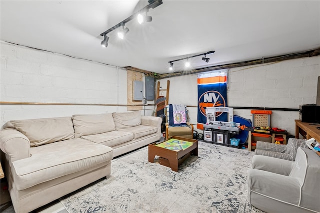 living area with electric panel and concrete block wall