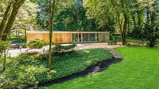 319 Pound Ridge Rd, Bedford, NY 10506 - rear view of house featuring a patio area and a yard