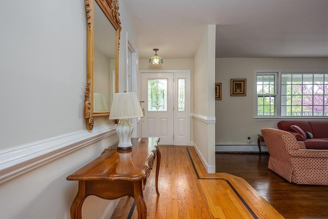 26 Strathmore Dr, New City, NY 10956 - foyer entrance with a baseboard heating unit and wood finished floors
